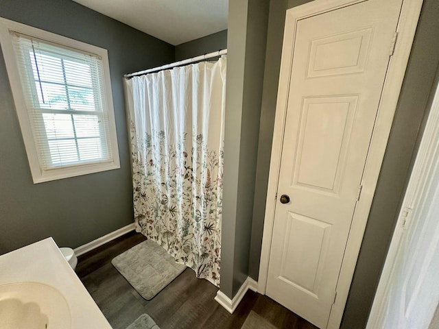 bathroom with hardwood / wood-style flooring and curtained shower