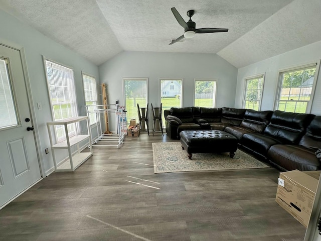 living room with ceiling fan, a textured ceiling, and lofted ceiling