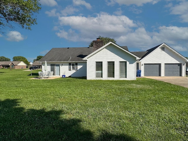 1216 Maple Hill Dr, Somerset, KY 42503 - back of property featuring a lawn, an attached garage, concrete driveway, a chimney, and a shingled roof