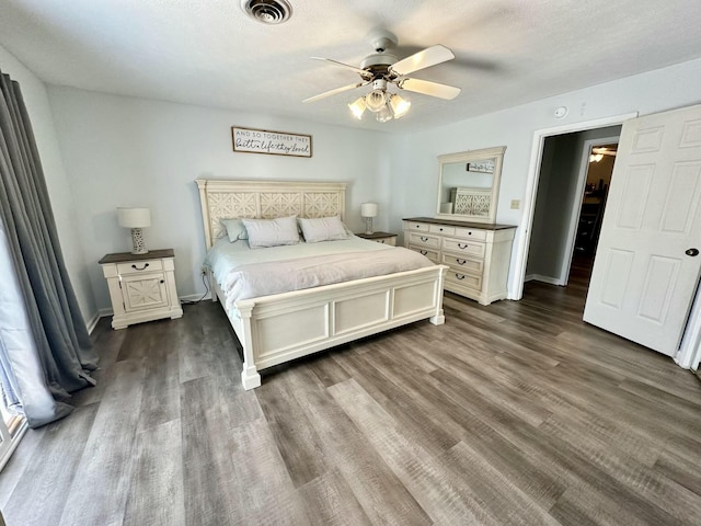 bedroom featuring ceiling fan and dark hardwood / wood-style flooring