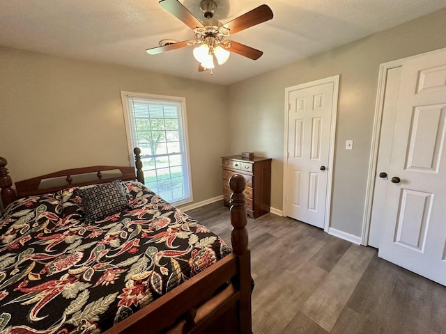 bedroom featuring ceiling fan and dark wood-type flooring