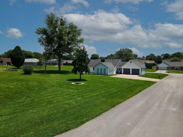 view of front of home with a garage and a front yard