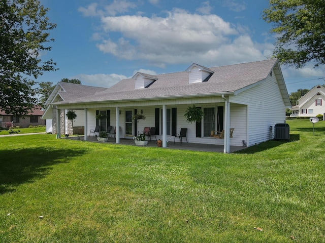 back of property featuring central AC unit, a porch, and a yard