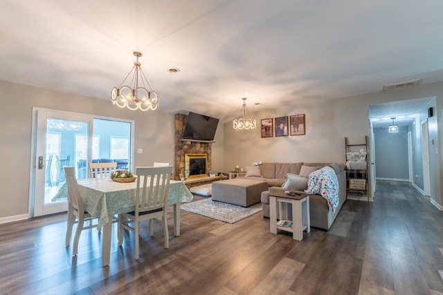 1216 Maple Hill Dr, Somerset, KY 42503 - dining area featuring a chandelier, dark wood-style floors, a fireplace, and baseboards