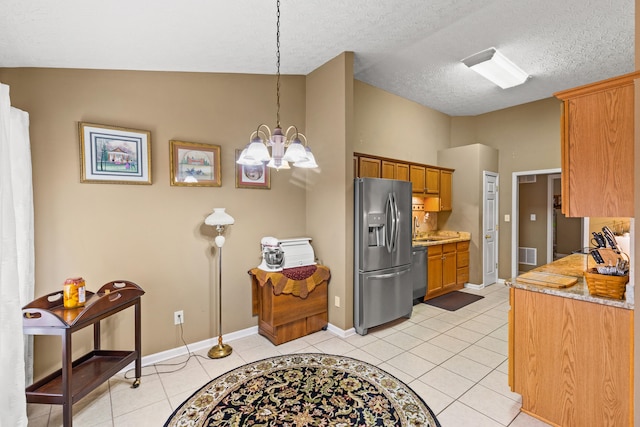 kitchen featuring vaulted ceiling, hanging light fixtures, light tile patterned floors, stainless steel appliances, and an inviting chandelier