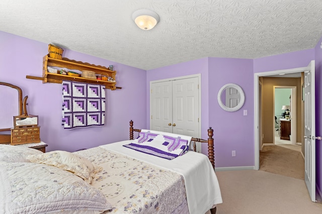 bedroom with carpet floors, a textured ceiling, and a closet