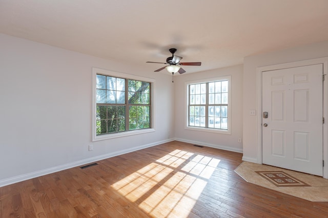 entrance foyer with ceiling fan and light hardwood / wood-style flooring