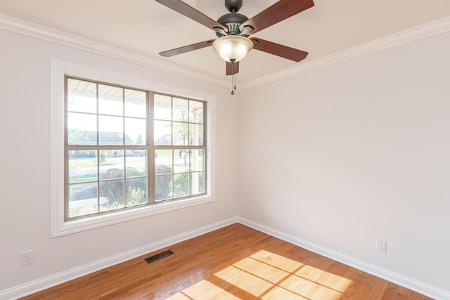 empty room featuring ceiling fan, crown molding, and light hardwood / wood-style flooring