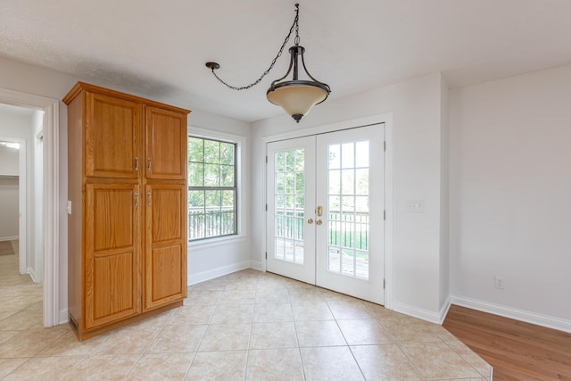 doorway featuring light tile patterned floors and french doors