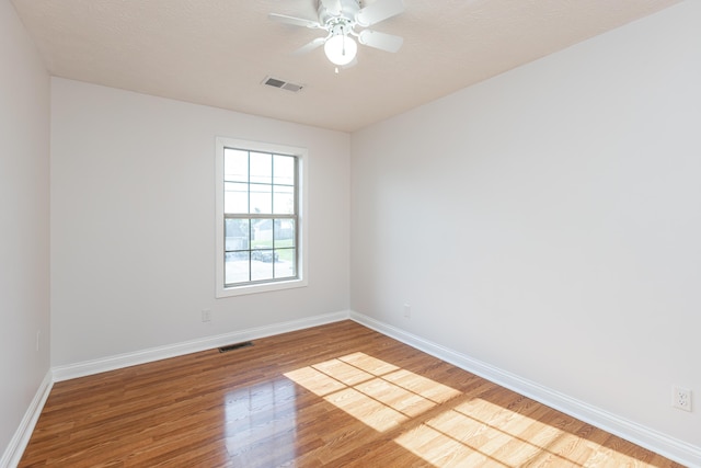 spare room with ceiling fan and light hardwood / wood-style flooring