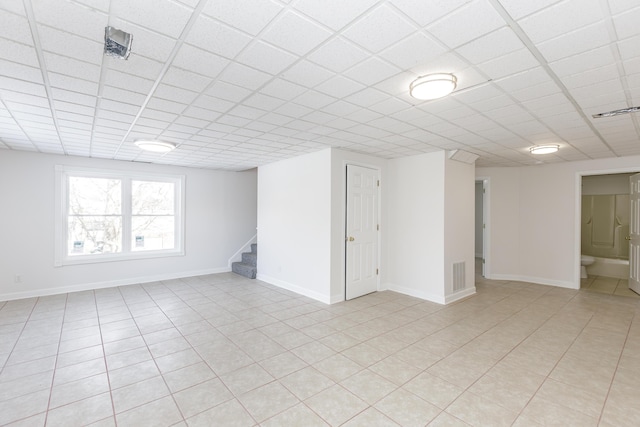 basement with a paneled ceiling