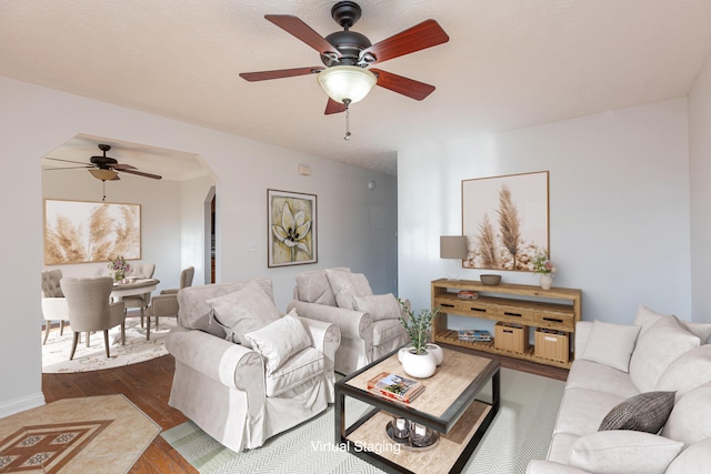 living room with ceiling fan and hardwood / wood-style floors