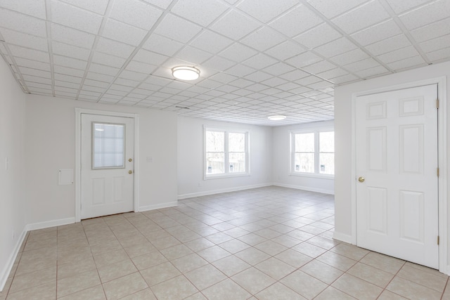 foyer entrance featuring a paneled ceiling and light tile patterned flooring