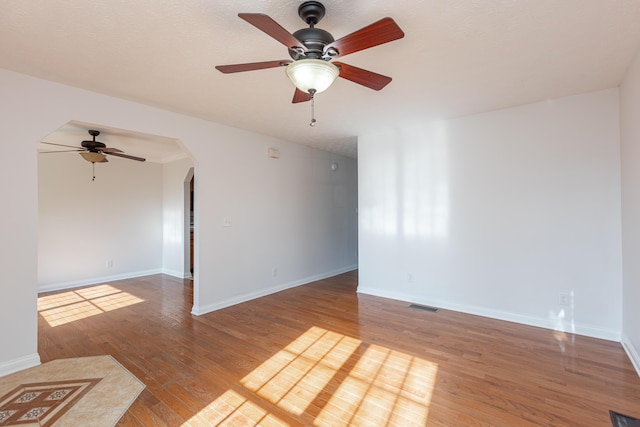 spare room with ceiling fan and wood-type flooring