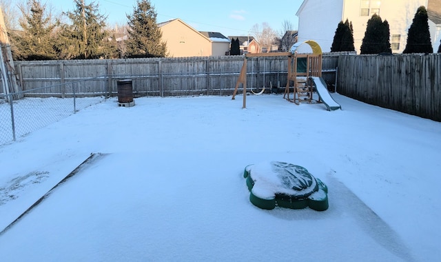 snowy yard with a playground