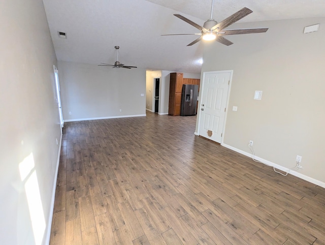 unfurnished living room with lofted ceiling, dark hardwood / wood-style floors, and ceiling fan