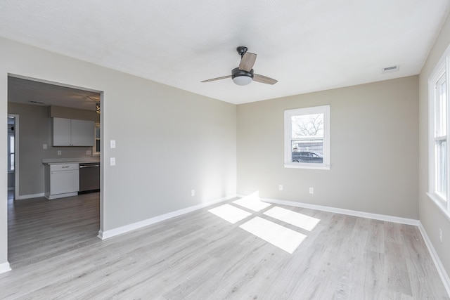 unfurnished room with light wood-type flooring and ceiling fan