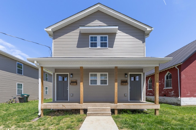 view of front facade with covered porch and a front lawn