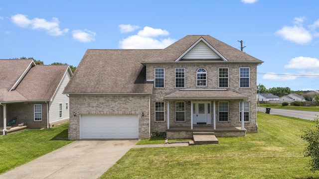 view of front facade with a garage, a front yard, and covered porch