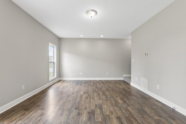 empty room with dark hardwood / wood-style flooring