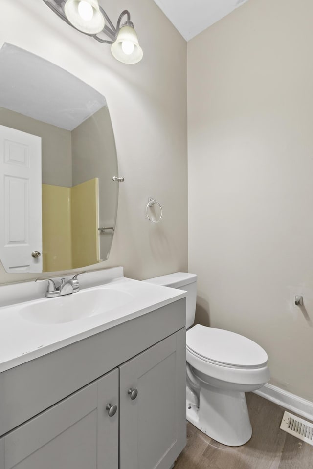 bathroom featuring a shower, wood-type flooring, toilet, and vanity