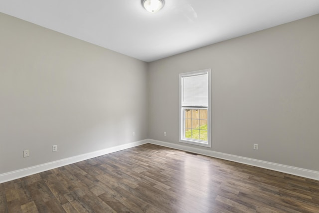 spare room with dark wood-type flooring