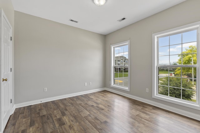 spare room featuring dark hardwood / wood-style flooring