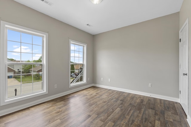 spare room featuring dark hardwood / wood-style floors