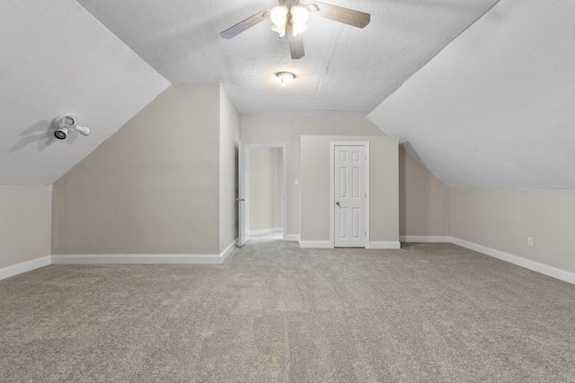 bonus room featuring light carpet, ceiling fan, a textured ceiling, and vaulted ceiling