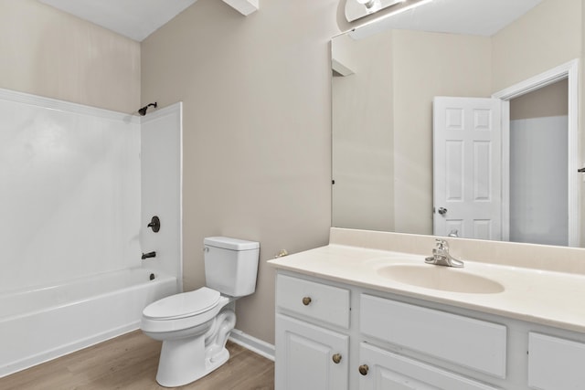 full bathroom featuring toilet, wood-type flooring, vanity, and bathtub / shower combination