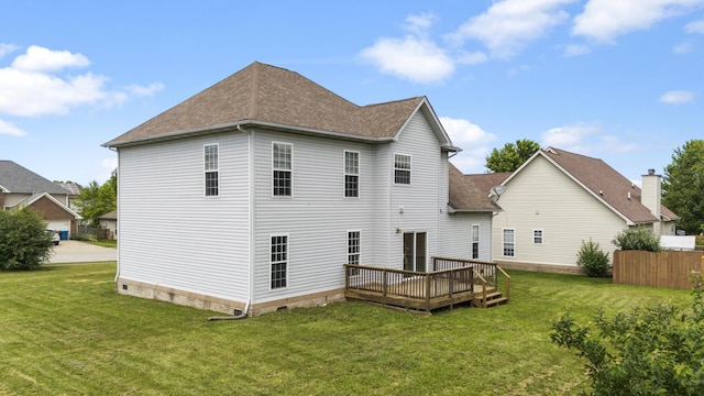 rear view of property featuring a deck and a lawn