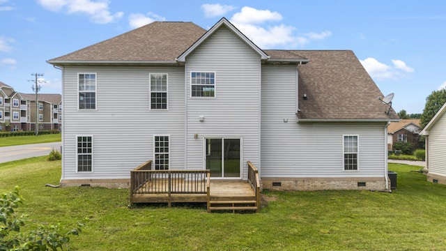 rear view of property featuring a deck, a yard, and central air condition unit