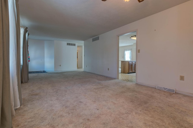 empty room with light carpet and ceiling fan