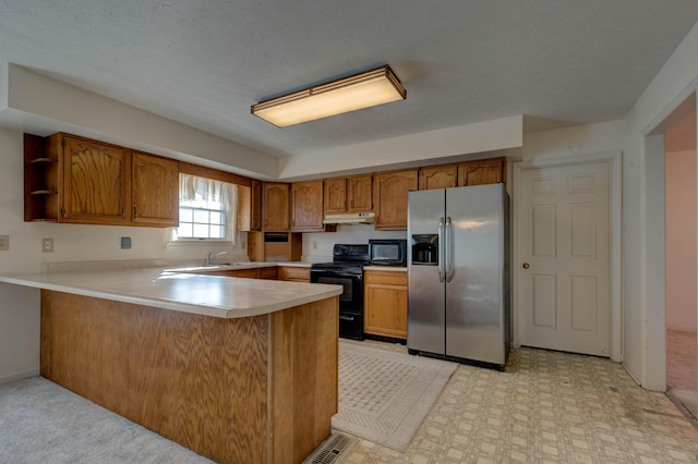 kitchen featuring sink, black appliances, and kitchen peninsula