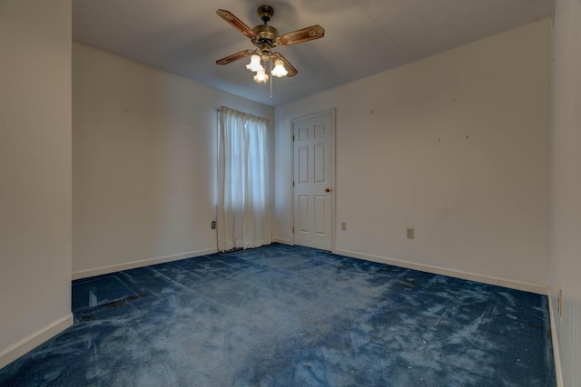 carpeted empty room featuring ceiling fan