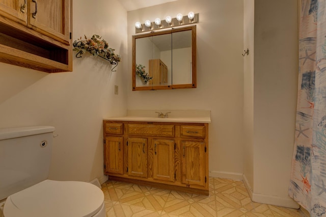 bathroom featuring toilet and vanity