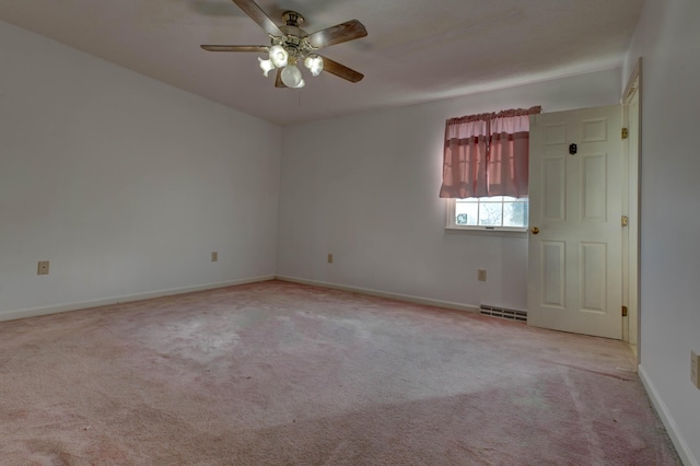 empty room with ceiling fan and light carpet