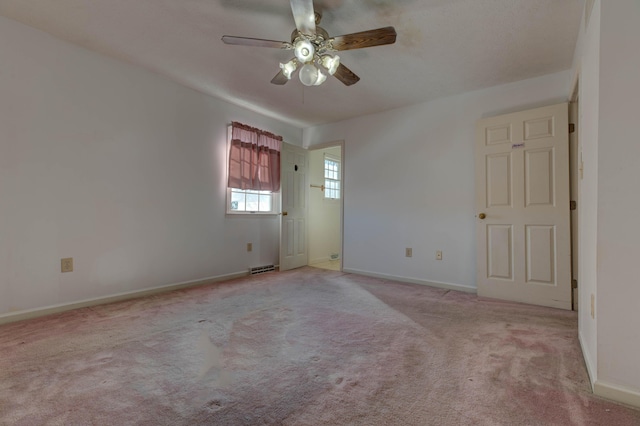 empty room featuring ceiling fan and light colored carpet