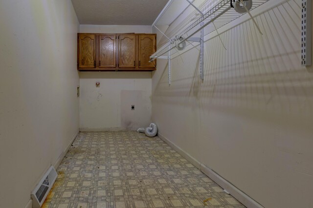 washroom featuring cabinets and hookup for an electric dryer