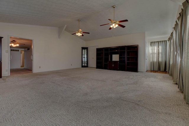 unfurnished living room with lofted ceiling and light colored carpet