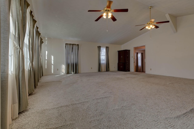 spare room with light carpet and high vaulted ceiling