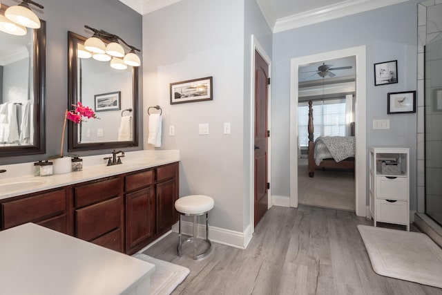 bathroom with hardwood / wood-style floors, vanity, and ornamental molding