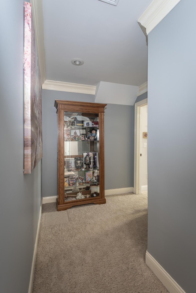 hall with carpet and ornamental molding