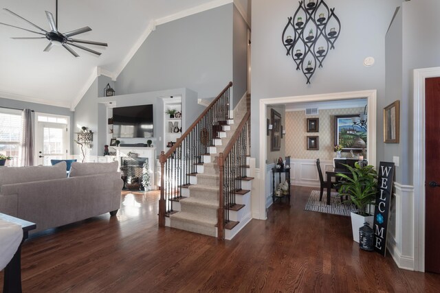 interior space featuring ceiling fan, ornamental molding, hardwood / wood-style floors, and high vaulted ceiling