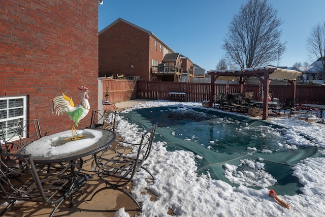 snow covered pool with a pergola