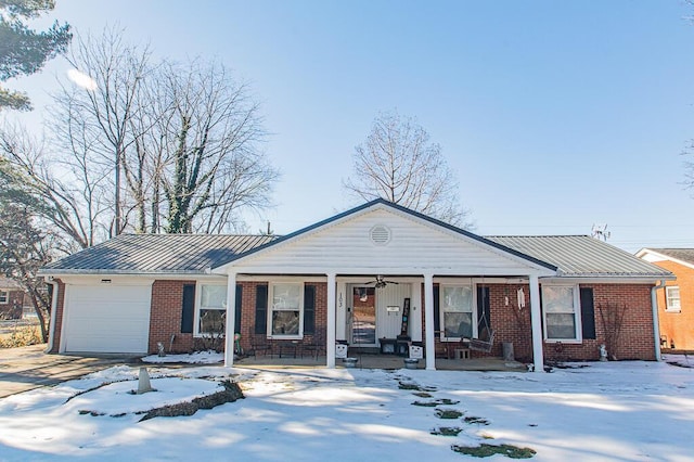 ranch-style house featuring a garage and covered porch