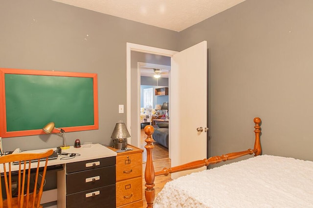 bedroom featuring hardwood / wood-style flooring and a textured ceiling