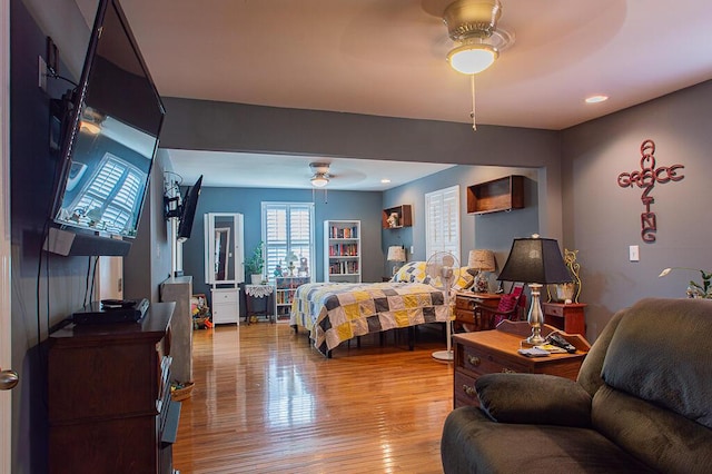 bedroom with a ceiling fan and wood finished floors