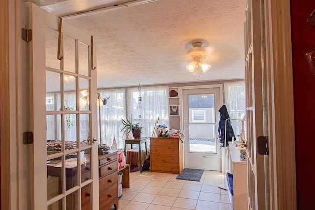 interior space with ceiling fan and a textured ceiling