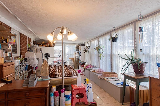 kitchen featuring a wealth of natural light, a textured ceiling, and light tile patterned floors